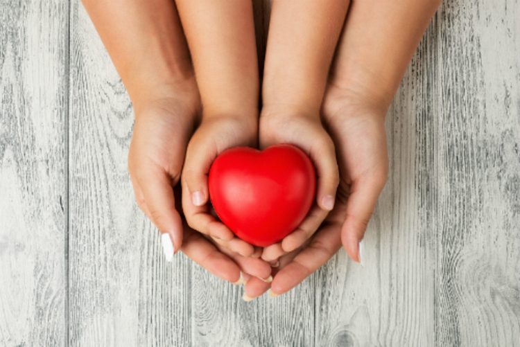 parent and child holding a heart